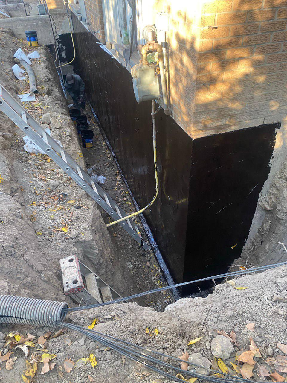 Foundation waterproofing membrane applied